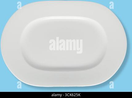 A simple white oval platter, designed for serving food elegantly. Stock Photo