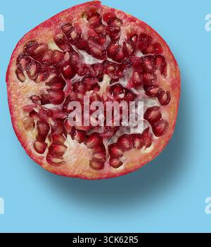 A cross-section of a pomegranate showcasing its juicy seeds and vibrant color. Stock Photo
