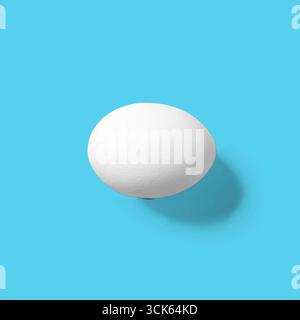 A simple, smooth white egg on a plain background, highlighting its shape and texture. Stock Photo