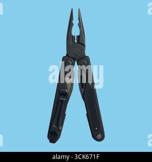 A black multi-tool plier designed for various tasks, featuring gripping jaws and additional tools for convenience. Stock Photo