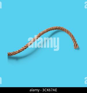 A curved piece of brown rope, showcasing texture and flexibility. Stock Photo
