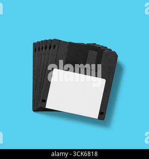 A stack of five black floppy disks, commonly used for data storage in older computers. Stock Photo