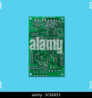A printed circuit board (PCB) featuring various electronic components and connections for circuit design and functionality. Stock Photo
