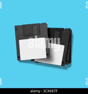 A stack of black floppy disks, commonly used for data storage in older computer systems. Stock Photo