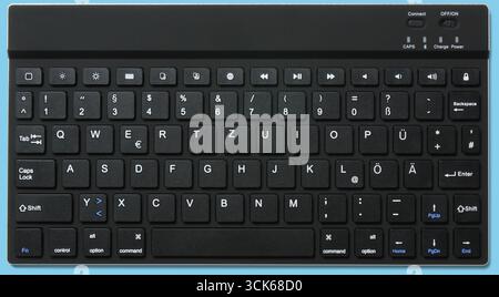 A wireless keyboard featuring a compact layout with multimedia keys for easy navigation and control. Stock Photo