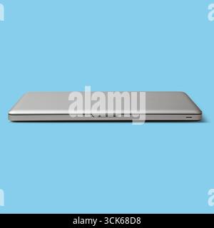 A sleek, silver laptop closed and resting on a flat surface, representing modern technology and design. Stock Photo