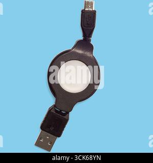 A retractable USB cable with micro USB and standard USB connectors for convenient charging and data transfer. Stock Photo