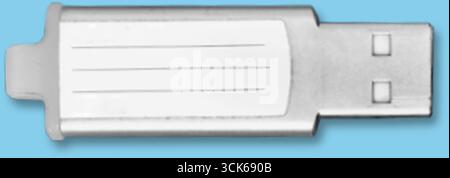 A silver USB flash drive with a blank label for customization. Stock Photo