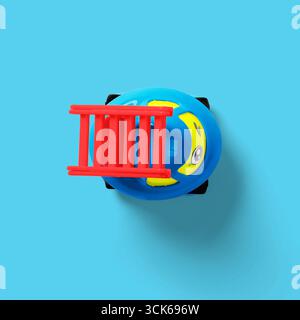 An inflatable toy designed for water play, featuring a blue base with a red ladder and playful design elements. Stock Photo
