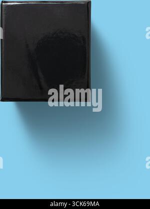 A simple, glossy black box with a smooth surface, suggesting a potential gift or storage item. Stock Photo
