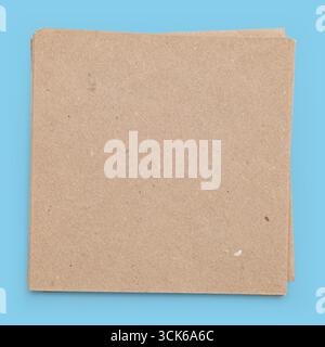 A stack of plain, brown, textured paper sheets, often used for crafts, notes, or packaging. Stock Photo