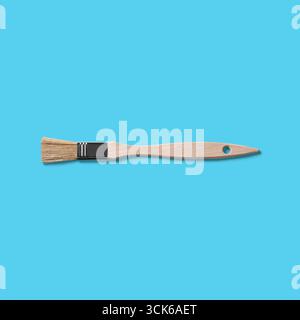 A wooden paintbrush with natural bristles, typically used for painting and crafting. Stock Photo