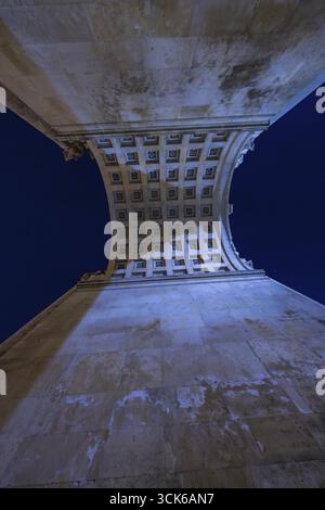 View from below through a vaulted arcade with illuminated night sky, Siegestor, Munich, Germany Stock Photo