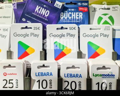 Kiel, Germany - 08. September 2025: Google Play gift cards displayed for sale alongside various brand cards like Vodafone, Lebara, and Xbox in a retai Stock Photo