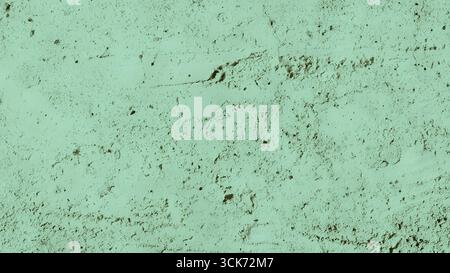 A textured surface featuring a muted green hue, resembling rough concrete or plaster. Stock Photo