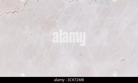 A close-up view of a textured surface with light cracks and variations in color, resembling natural stone or marble. Stock Photo