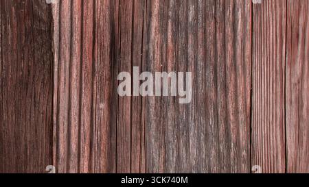 A textured wooden surface featuring varying shades and grooves, ideal for backgrounds or rustic design elements. Stock Photo