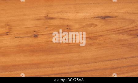 A close-up view of a polished wooden surface showcasing its natural grain and texture. Stock Photo