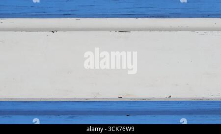 A textured surface featuring horizontal stripes in varying shades of blue and white, creating a visually appealing pattern. Stock Photo