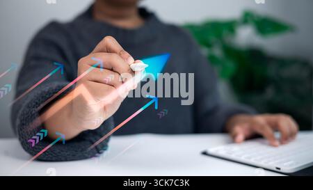 Business hand using digital pen drawing rising arrows on virtual screen symbolizing growth, progress, success, and financial achievement in modern bus Stock Photo