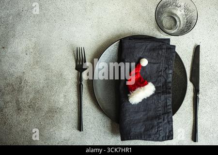 Table setting for festive Christmas dinner on concrete table Stock Photo