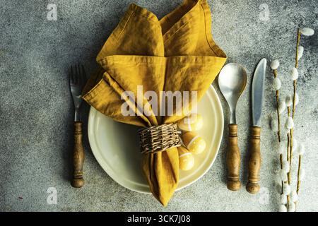 Easter dinner place setting on concrete background Stock Photo