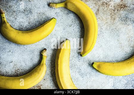 Ripe yellow banana fruits on concrete background with copy space Stock Photo