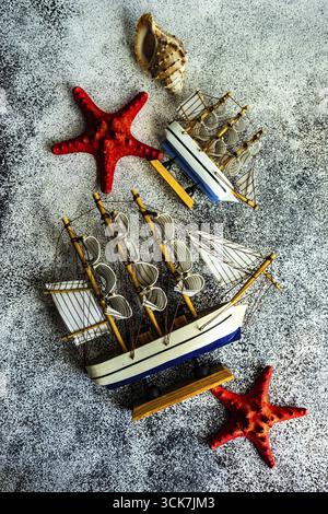 Flat lay summer composition with sea star and sailboat Stock Photo