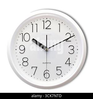 A round wall clock displaying the time with clear numbers and hands. Stock Photo