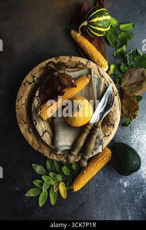 Autumnal table setting with ripe pupking for Thanksgiving holiday dinner Stock Photo