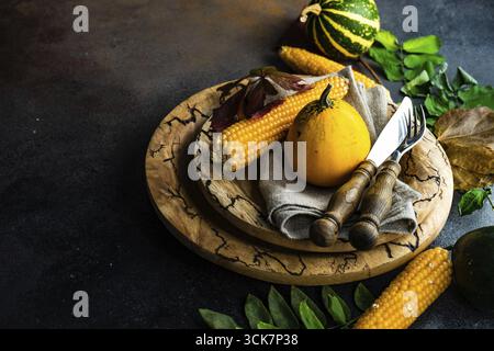 Autumnal table setting with ripe pupking for Thanksgiving holiday dinner Stock Photo