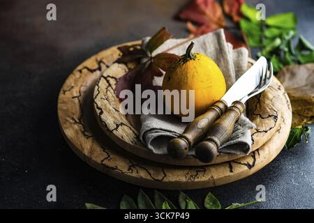Autumnal table setting with ripe pupking for Thanksgiving holiday dinner Stock Photo