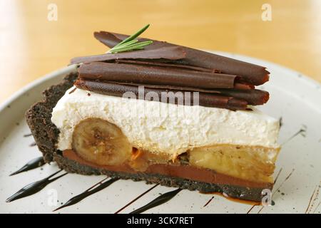 A Slice of Delectable Banoffee Pie on a White Plate Stock Photo