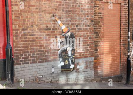 Street art stencil mural on side of the Dog and Partridge pub building on Trippet Lane in Sheffield city centre England UK Stock Photo