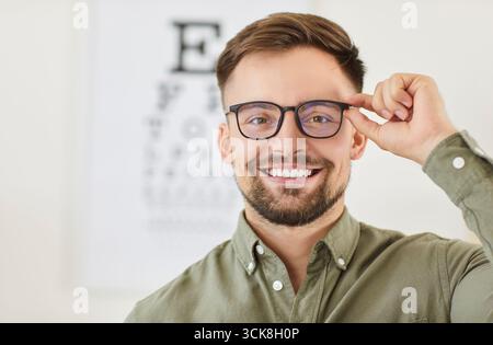 Portrait of a man wearing glasses in an optics store, close-up Stock Photo