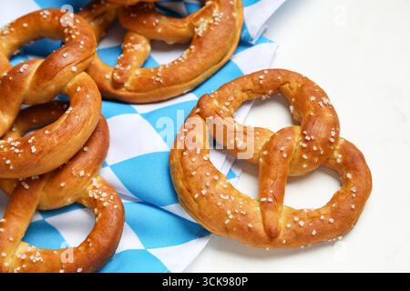 Napkin and tasty pretzels on marble background, closeup Stock Photo