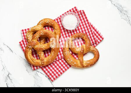 Napkin and tasty pretzels on marble background, closeup Stock Photo
