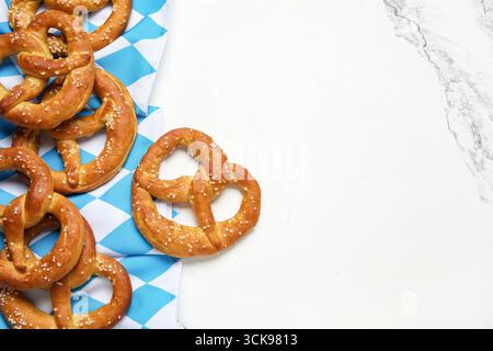 Napkin and tasty pretzels on marble background, closeup Stock Photo