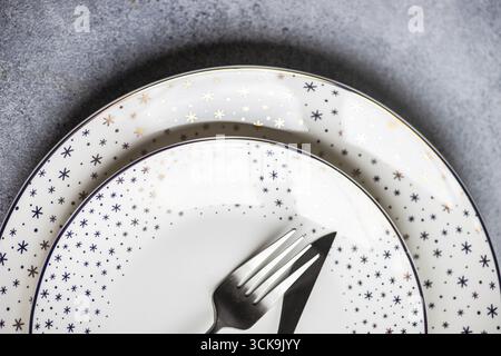 Minimalistic table setting for Christmas dinner on white concrete table Stock Photo