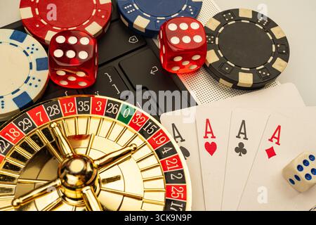 Image showcases a casino setting with playing cards, roulette wheel, dice, and neutral backdrop a Stock Photo