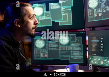Cybercriminal using malicious script to compromise devices and digital networks, gaining passwords. Black hat hacker stealing, exploiting and illegally selling data online Stock Photo