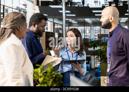Ambitious work team collaborates on a financial planning project in an office, emphasizing teamwork and data analysis to make informed decisions for future organizational development. Stock Photo