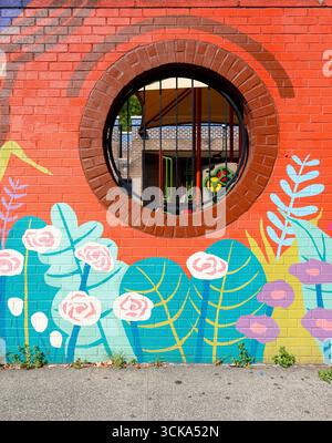 A round portal on a colorfully painted masonry brick wall. Stock Photo