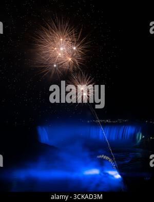 Niagara Falls fireworks over Horseshoe Falls - blurry waterfall at night color / colored lights on blurred Waterfalls colourful  / colour reflections Stock Photo