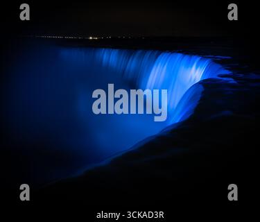 Niagara Falls waterfall night red & white color - colored lights on Niagara Waterfalls colourful gorge / colour reflections Stock Photo
