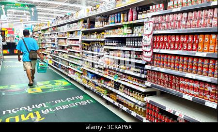 Bangkok, Thailand - November 28, 2024 : Series of Asian man shopping groceries in modern supermarket selecting products in supermarket at LOTUS’S RAMA Stock Photo