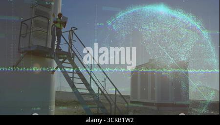 Inspecting technician using tablet on metal stairs in yard with tank, globe overlay, copy space Stock Photo