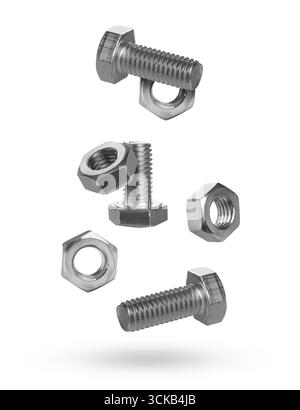 Metal nuts and bolts falling against white background Stock Photo