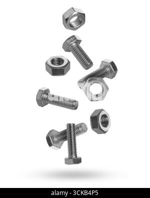 Metal nuts and bolts falling against white background Stock Photo