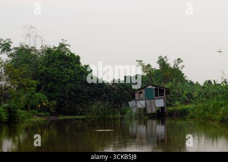 scene of a vietnamese fishing hut over a lake in one of the industrial lakes in Hanoi city. Hanoi, Vietnam Stock Photo